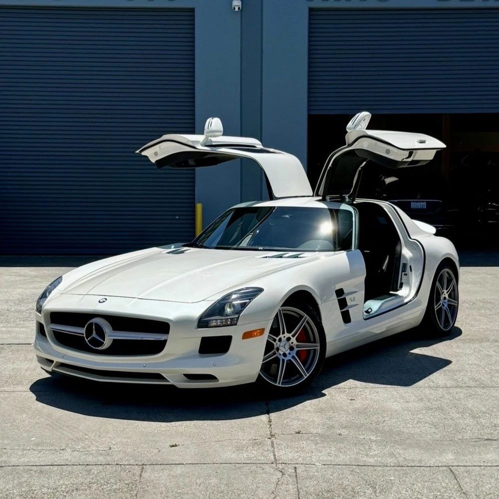 White Mercedes SLS with gullwing doors open after ceramic coating